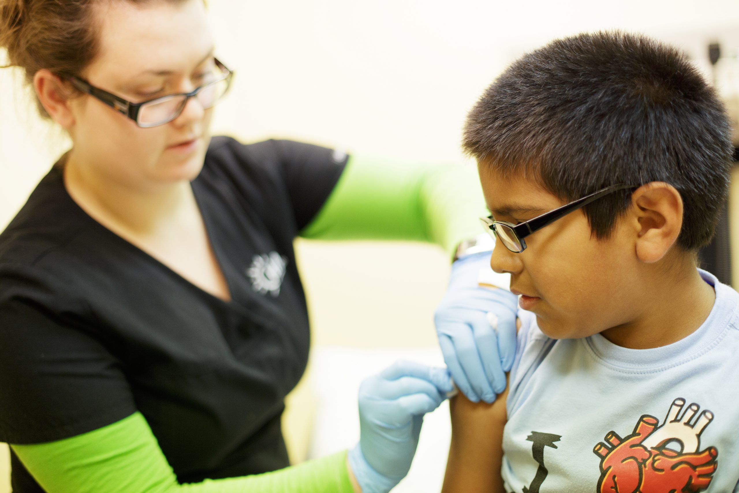 CHAS Health staff member examining a young patient