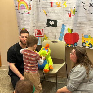 Hygienist Mickey teaches kids at the Colfax library proper brushing and flossing techniques.