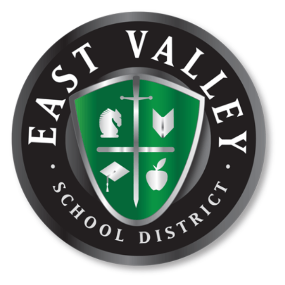 Green shield logo for East Valley School District with a central cross dividing icons of a knight helmet, book, graduation cap, and apple, surrounded by a black circular border with white text.